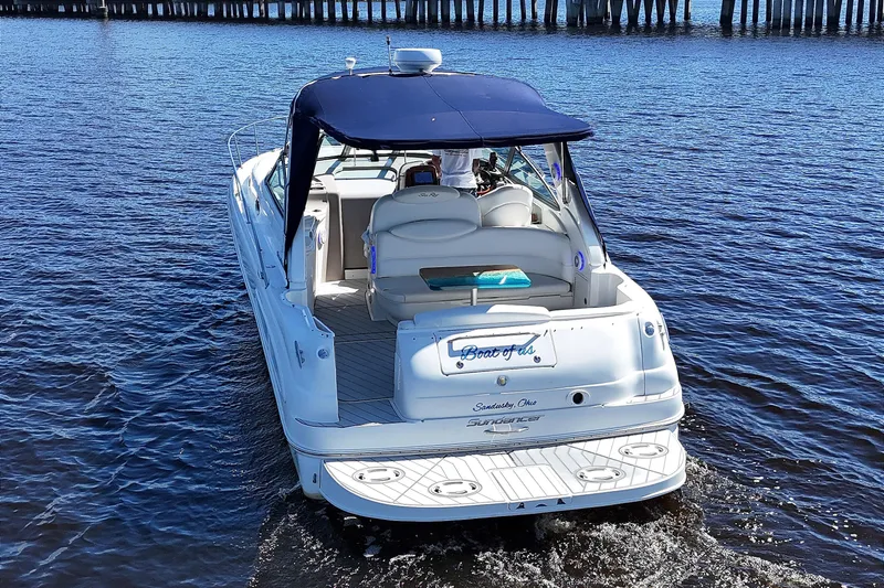 Slide: The Image of 2001 Sea Ray 340 Sundancer cruising on calm waters near a pier. - 2
