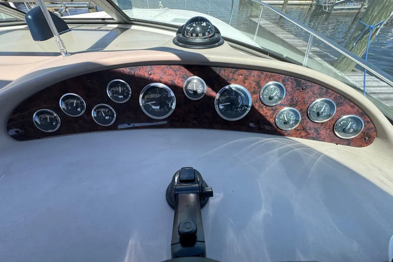 Slide: The Image of Dashboard of a 2001 Sea Ray 340 Sundancer boat with gauges and compass. - 21