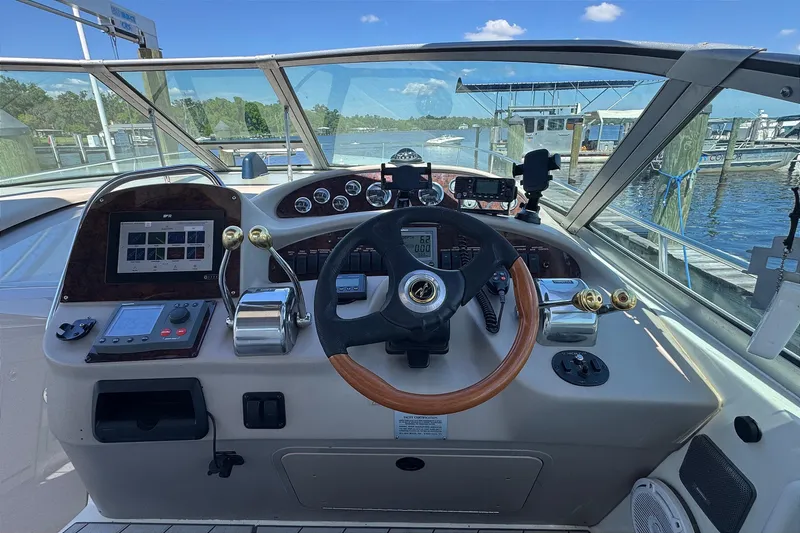 Slide: The Image of Cockpit view of 2001 Sea Ray 340 Sundancer boat with steering wheel and controls. - 23