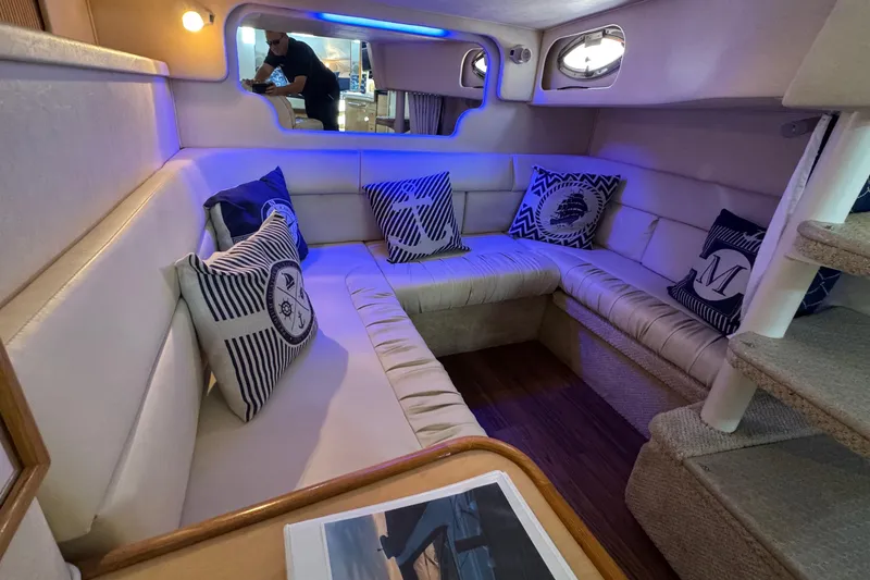 Slide: The Image of Luxurious interior of 2001 Sea Ray 340 Sundancer yacht with cozy seating and nautical decor. - 30