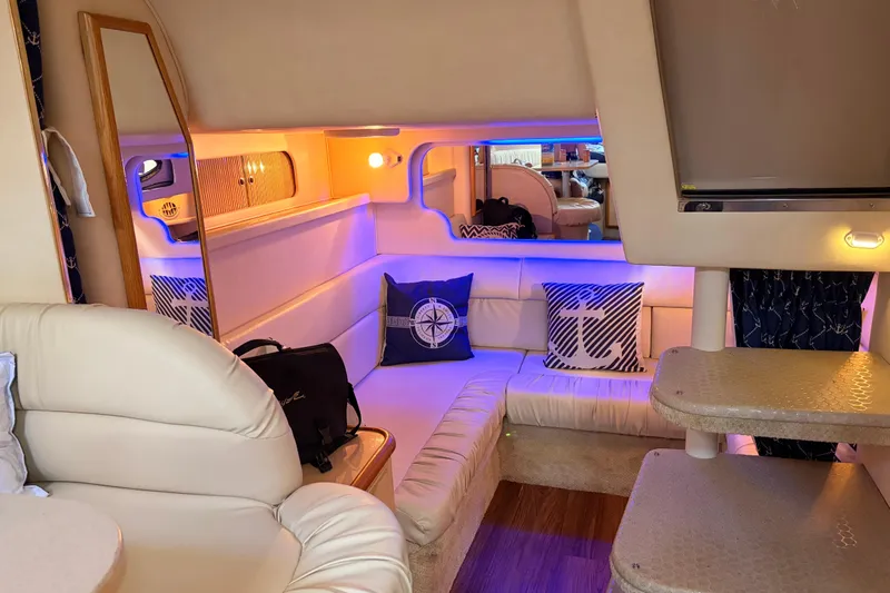 Slide: The Image of Luxurious interior of 2001 Sea Ray 340 Sundancer yacht with cozy seating and nautical decor. - 31