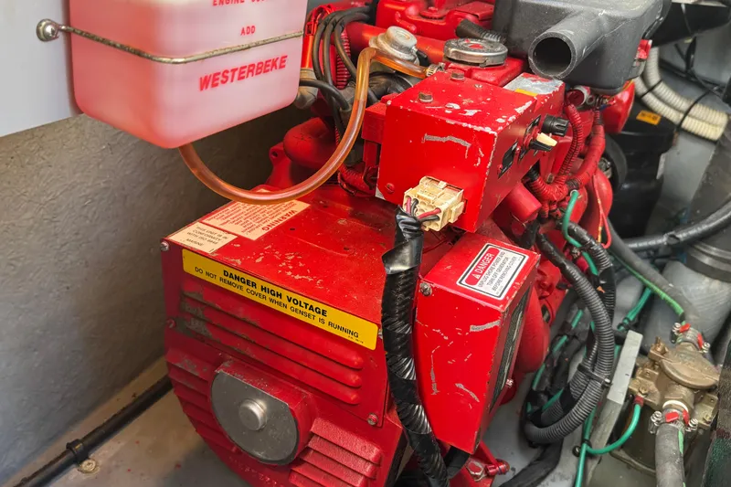 Slide: The Image of Red Westerbeke generator in a 2001 Sea Ray 340 Sundancer engine compartment. - 36