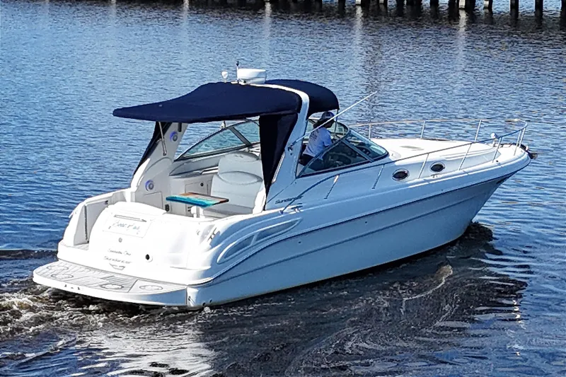 Slide: The Image of 2001 Sea Ray 340 Sundancer cruising on calm waters with a navy blue canopy. - 4
