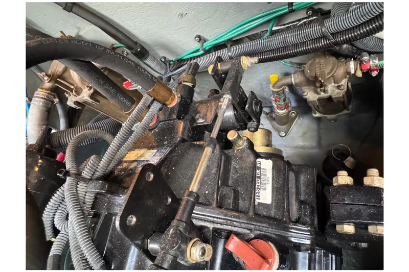 Slide: The Image of Engine compartment of a 2001 Sea Ray 340 Sundancer boat, showing hoses and mechanical components. - 46