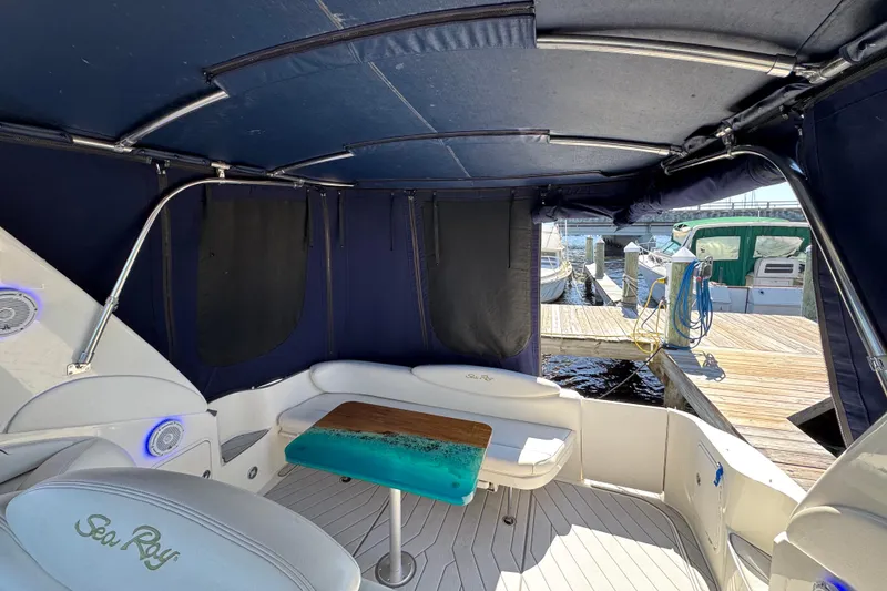 Slide: The Image of 2001 Sea Ray 340 Sundancer interior with seating and table, docked at marina. - 8