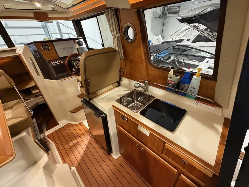 Slide: The Image of Interior of 2023 Ranger Tugs R 25 NW with kitchen and helm. - 8