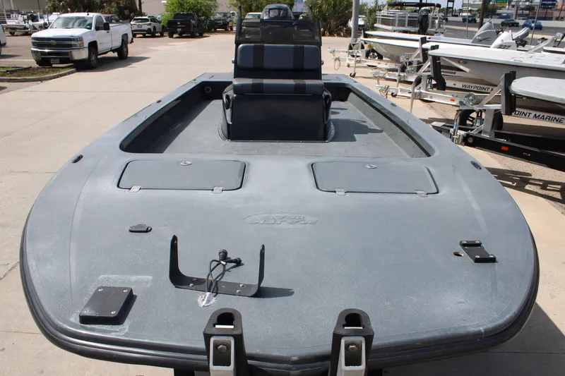 Slide: The Image of 2022 Majek 24 Reaper boat on display at a dealership, showcasing its sleek design. - 10