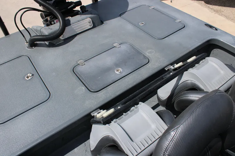 Slide: The Image of 2022 Majek 24 Reaper boat interior with storage compartments and seating. - 16