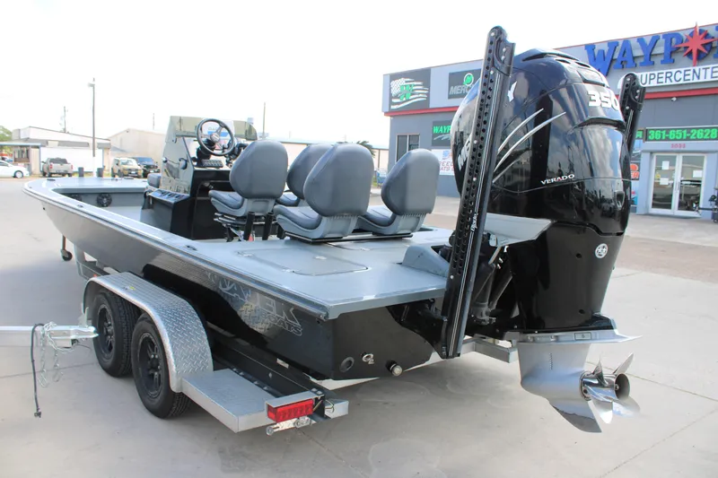 Slide: The Image of 2022 Majek 24 Reaper boat with powerful Verado engine, parked on a trailer. - 6