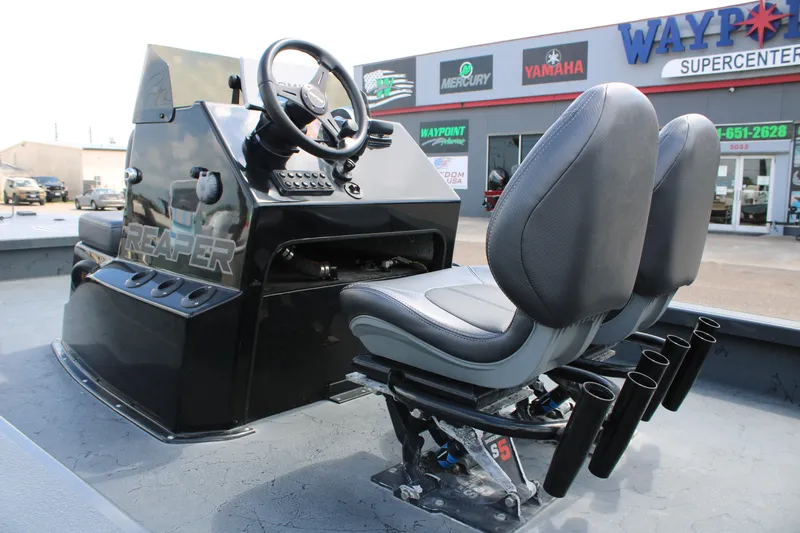 Slide: The Image of 2022 Majek 24 Reaper boat interior with dual seats and steering console. - 8