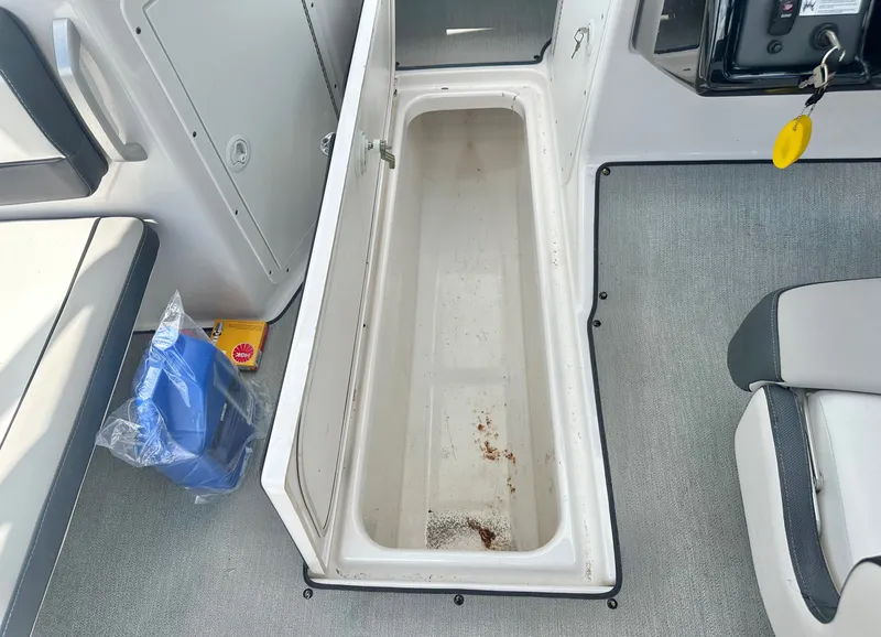 Slide: The Image of Yamaha AR195 2022 boat with open storage compartment and accessories. - 13