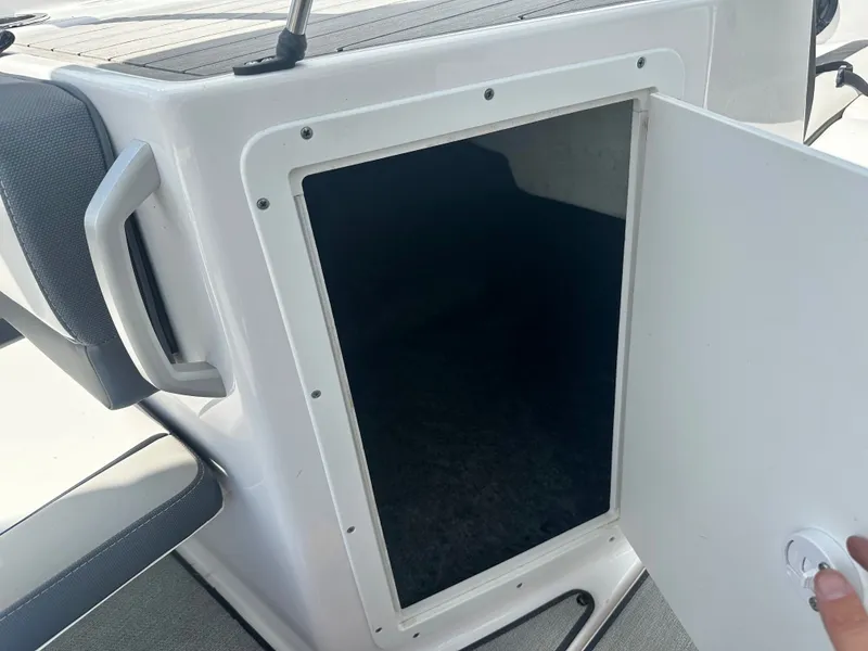Slide: The Image of Yamaha AR195 2022 boat storage compartment with open door. - 15