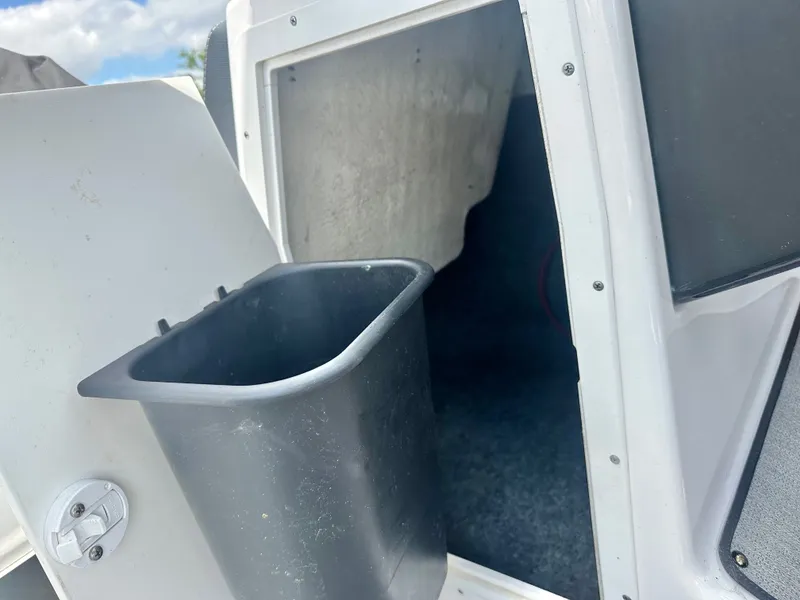 Slide: The Image of Yamaha AR195 2022 boat with open storage compartment and trash bin. - 16