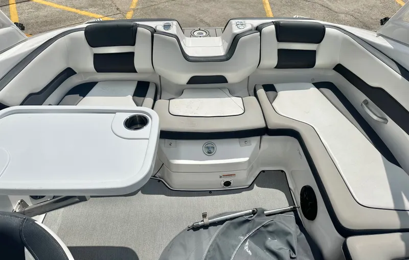 Slide: The Image of Interior of a 2022 Yamaha AR195 boat with seating area and table. - 19