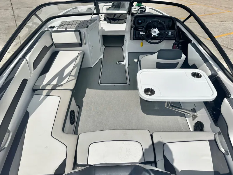 Slide: The Image of Interior of a 2022 Yamaha AR195 boat with seating area and table. - 20