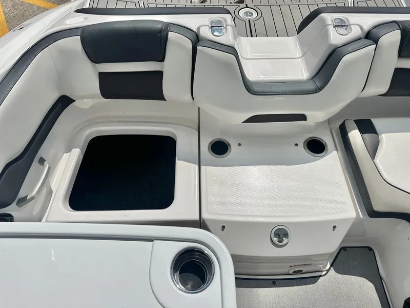 Slide: The Image of Interior of a 2022 Yamaha AR195 boat with seating and storage area. - 21