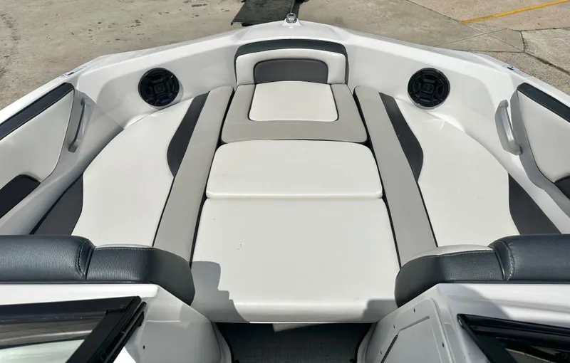 Slide: The Image of Interior of 2022 Yamaha AR195 boat with white and gray seating. - 8