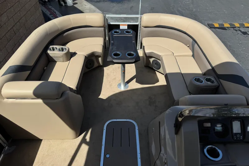 Slide: The Image of Interior of 2022 Bennington SX23 Salt Water Series pontoon boat with beige seating and table. - 10