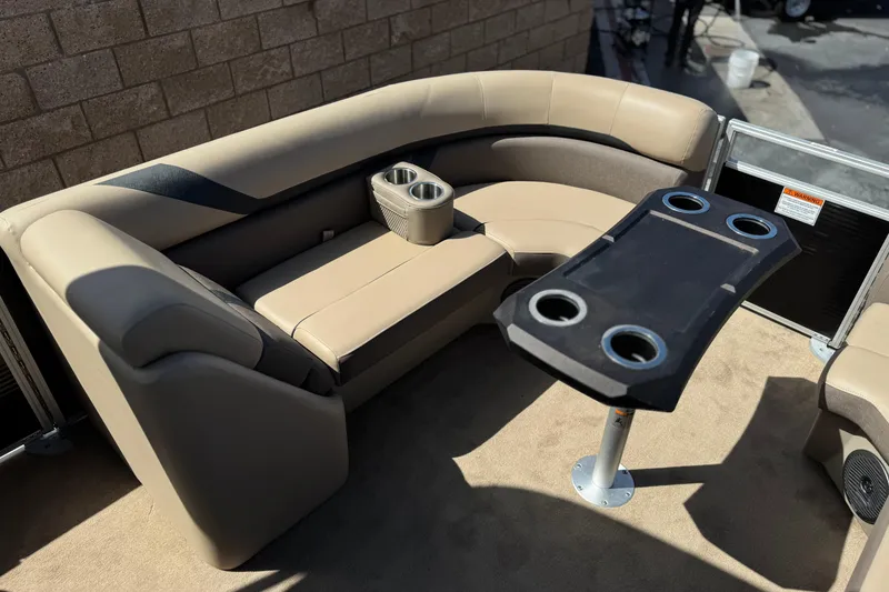 Slide: The Image of 2022 Bennington SX23 Salt Water Series boat interior with beige seating and cupholders. - 11
