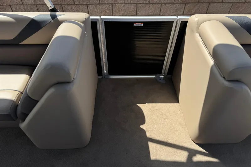 Slide: The Image of 2022 Bennington SX23 Salt Water Series boat interior with beige seating and gate. - 13