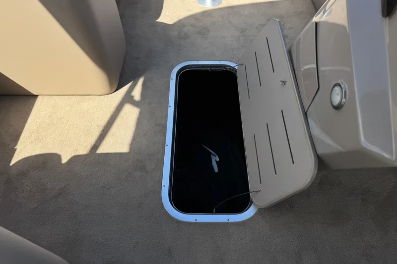 Slide: The Image of Open storage compartment on 2022 Bennington SX23 Salt Water Series boat deck. - 14