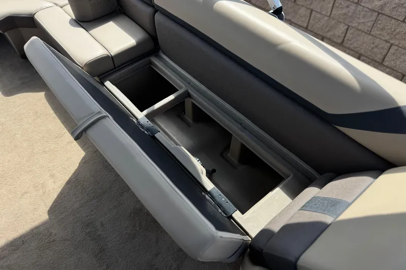 Slide: The Image of Open storage compartment on 2022 Bennington SX23 Salt Water Series boat seat. - 18