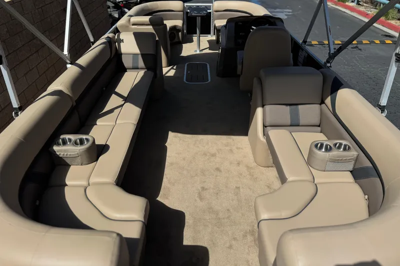 Slide: The Image of 2022 Bennington SX23 Salt Water Series boat interior with beige seating and cup holders. - 21
