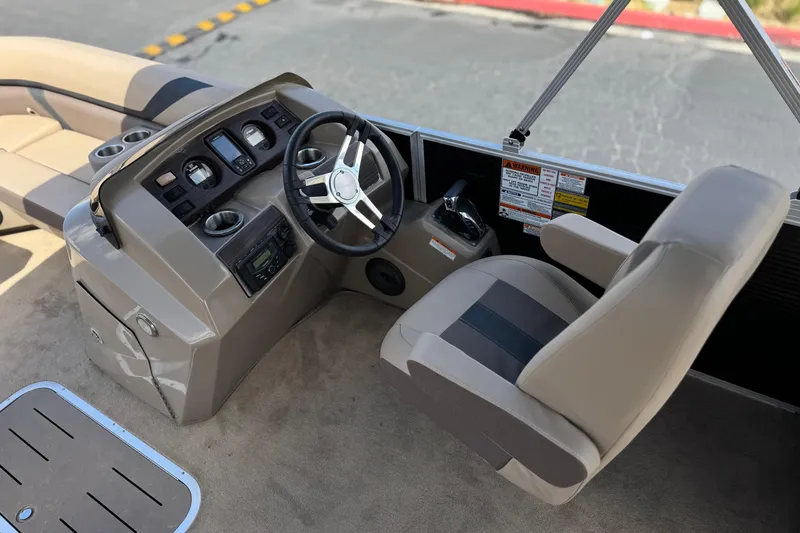 Slide: The Image of 2022 Bennington SX23 Salt Water Series boat cockpit with steering wheel and controls. - 22