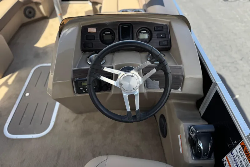 Slide: The Image of Steering console of 2022 Bennington SX23 Salt Water Series boat, featuring modern controls. - 23