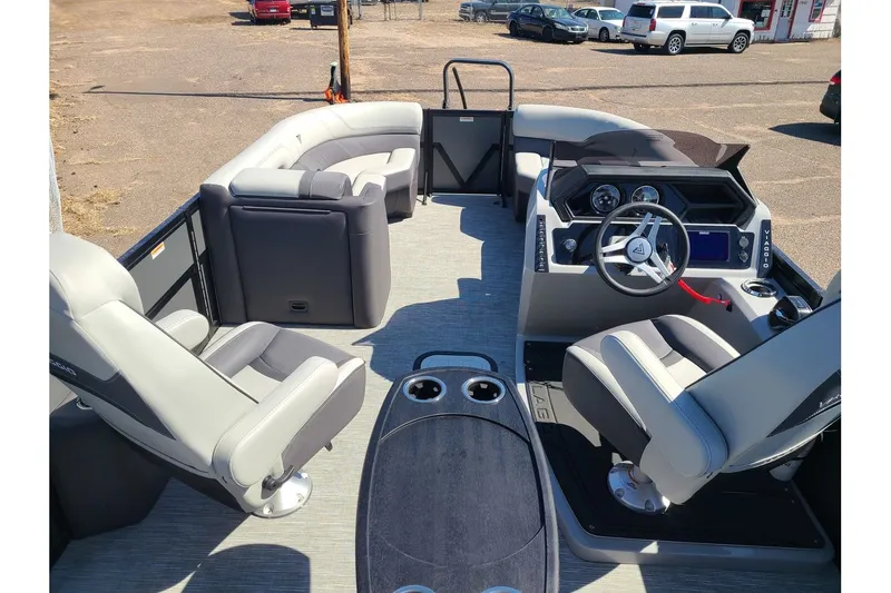 Slide: The Image of Interior of 2025 Viaggio Lago Z22Q with modern seating and helm console. - 13