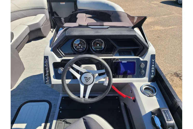 Slide: The Image of Viaggio Lago Z22Q 2025 boat console with steering wheel and instruments. - 15