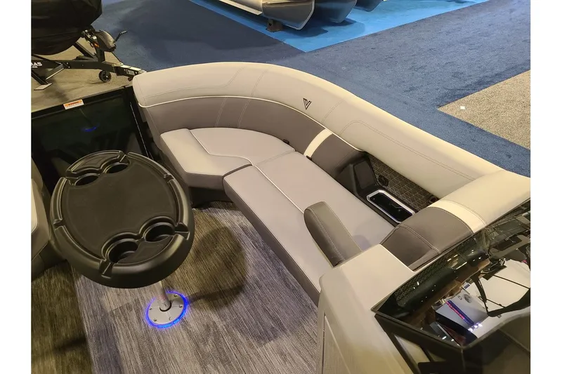 Slide: The Image of Interior of 2026 Viaggio Lago Z22U Tritoon with gray seating and table. - 20