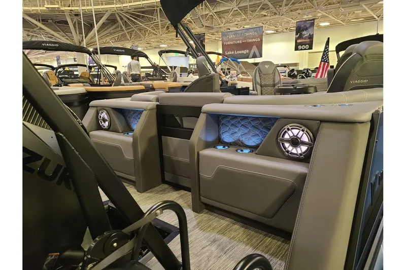 Slide: The Image of Interior of 2026 Viaggio Diamante 24Q Tritoon with luxurious seating and speakers. - 13