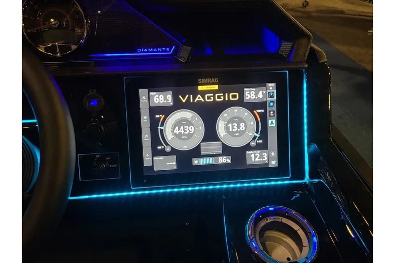 Slide: The Image of Viaggio Diamante 24Q Tritoon 2026 dashboard with digital display and blue lighting. - 18