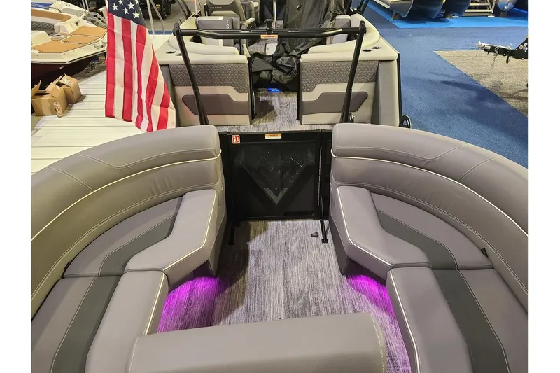 Slide: The Image of Interior of 2026 Viaggio Diamante 24Q Tritoon with gray seating and US flag. - 21
