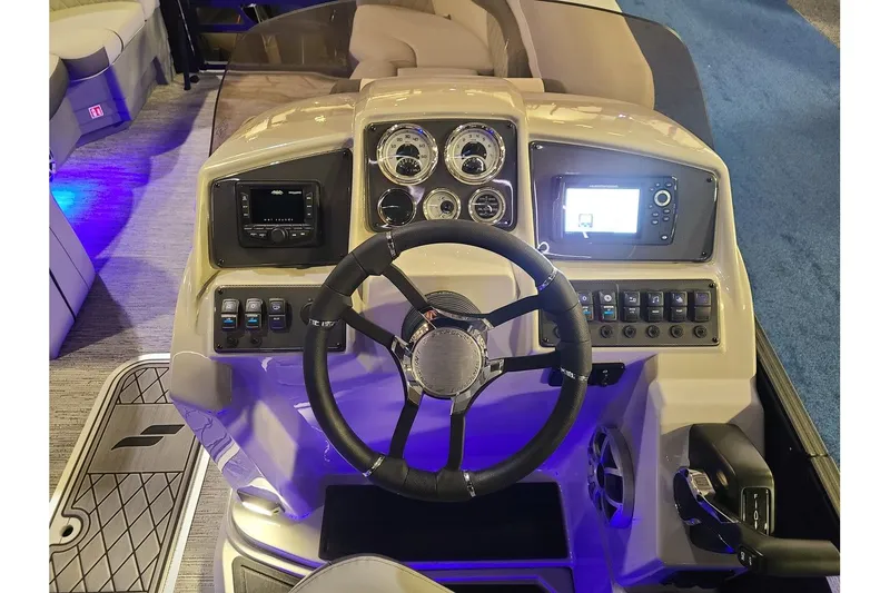 Slide: The Image of Starcraft EXS 3 DL 2026 boat console with steering and instruments. - 15