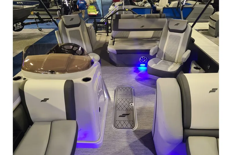 Slide: The Image of Interior of 2026 Starcraft EXS 3 DL with modern seating and blue lighting. - 4