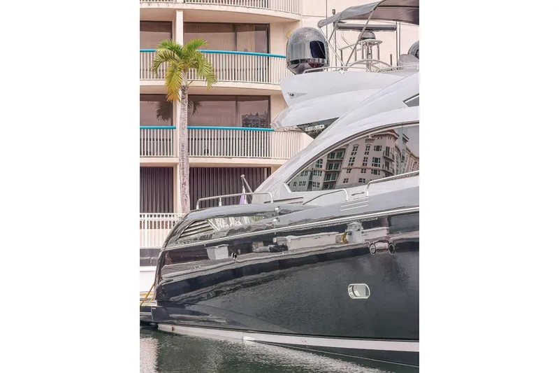 The Image of Luxury Sunseeker Predator 84 yacht docked near modern building, 2010 model. - 0
