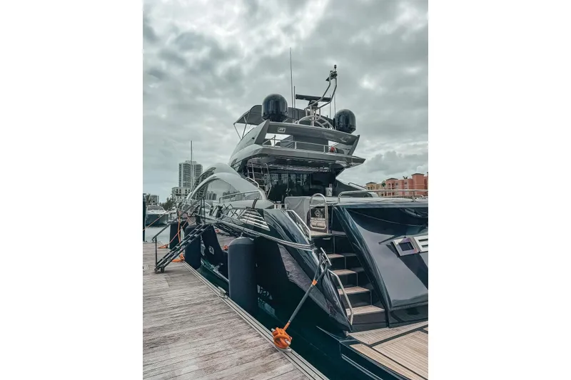 The Image of Luxurious 2010 Sunseeker Predator 84 yacht docked under cloudy skies. - 1