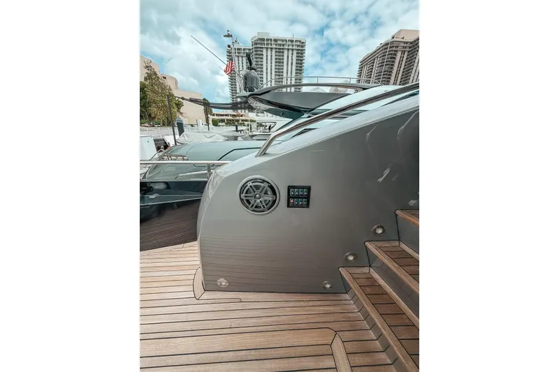 Slide: The Image of Luxury Sunseeker Predator 84 yacht docked, 2010 model, with modern architecture in the background. - 17