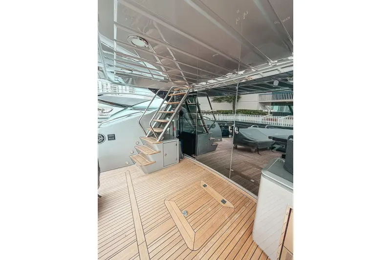 Slide: The Image of Sunseeker Predator 84 yacht docked in a marina with city skyline, 2010 model. - 18