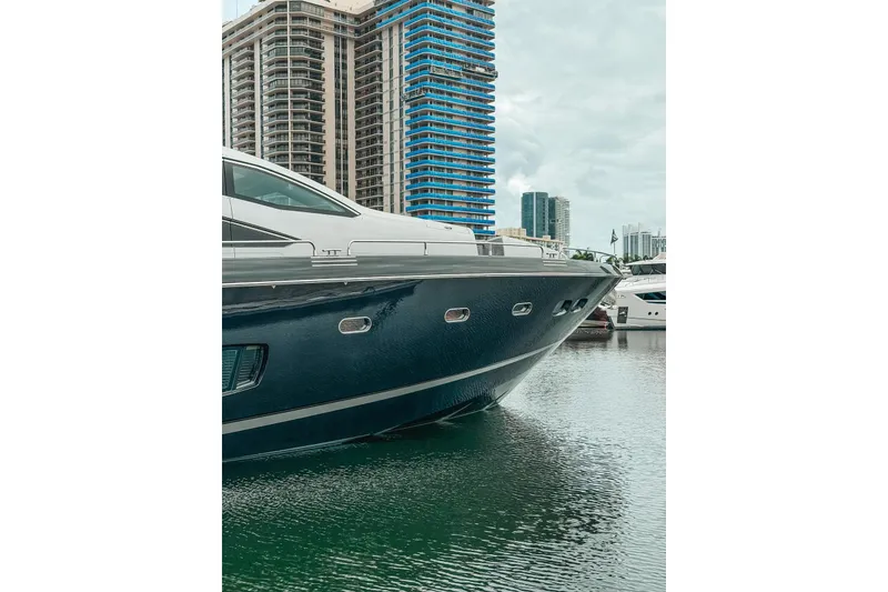 Slide: The Image of Luxurious 2010 Sunseeker Predator 84 yacht docked in a marina with cityscape backdrop. - 40