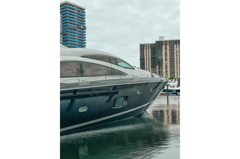 Slide: The Image of 2010 Sunseeker Predator 84 yacht docked in a marina with city skyline. - 42