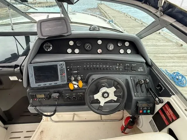 Slide: The Image of 1993 Sea Ray 38 Express cockpit with controls and instruments. - 12