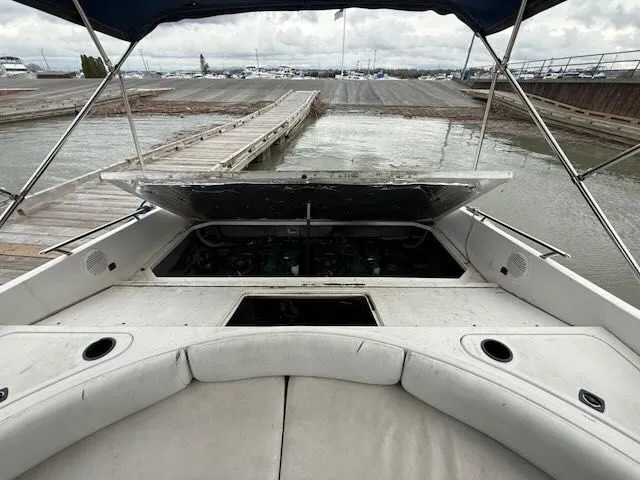 Slide: The Image of 1993 Sea Ray 38 Express boat at dock with open engine compartment. - 14