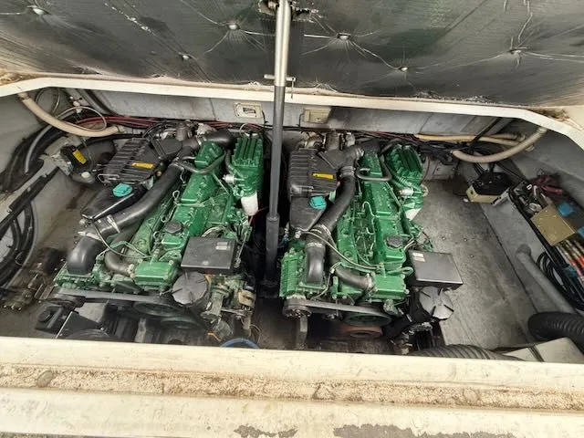 Slide: The Image of Engine room of a 1993 Sea Ray 38 Express with twin green engines. - 15