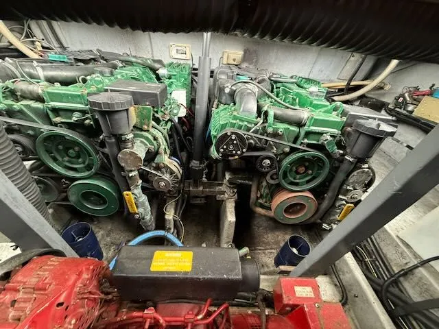Slide: The Image of Engine room of a 1993 Sea Ray 38 Express boat with green engines. - 16