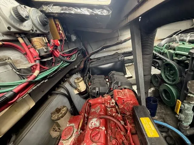 Slide: The Image of Engine room of a 1993 Sea Ray 38 Express boat with red and green engines. - 21