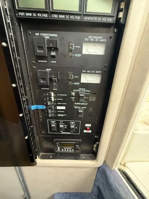 Slide: The Image of Control panel of 1993 Sea Ray 38 Express with various switches and gauges. - 24