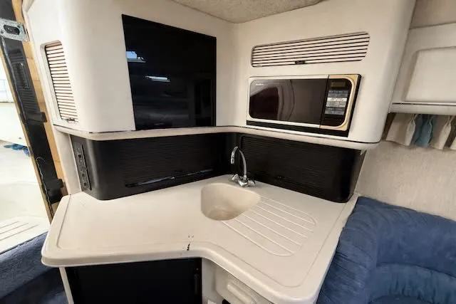 Slide: The Image of 1993 Sea Ray 38 Express yacht interior with kitchenette. - 27